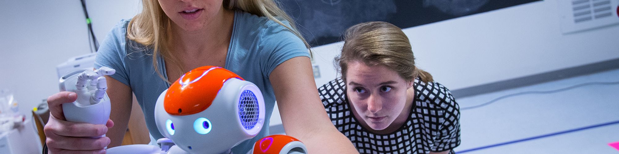female students working on robot